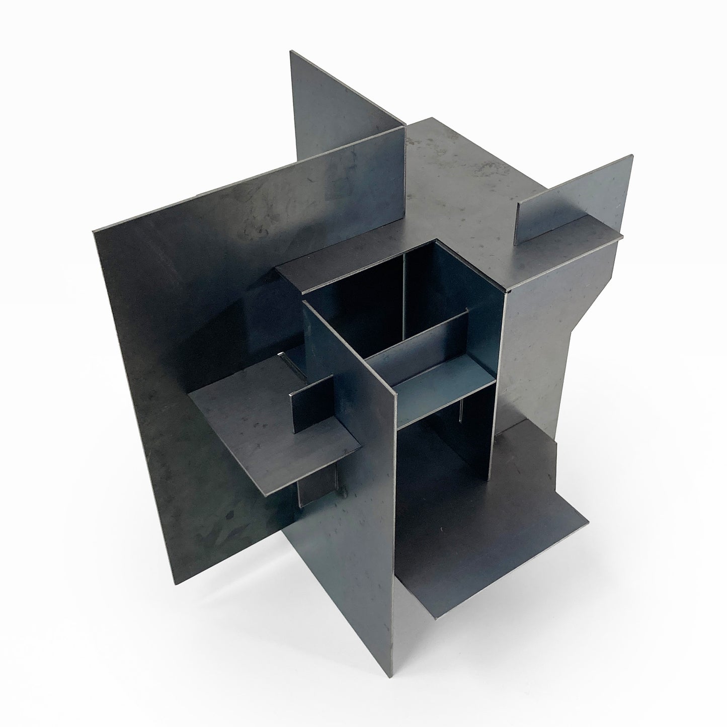 Metallic geometric sculpture on a white background