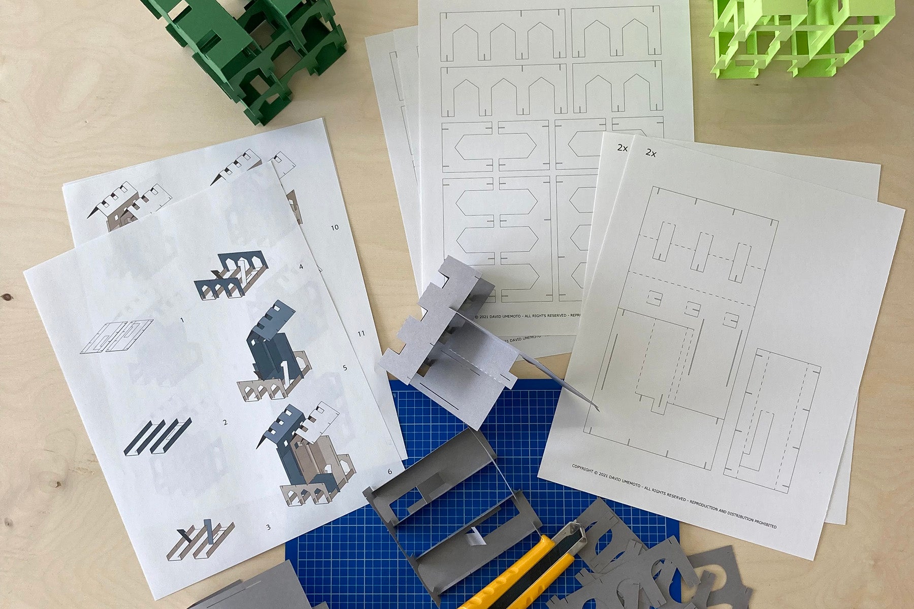 Construction paper set with blueprints and tools on a table