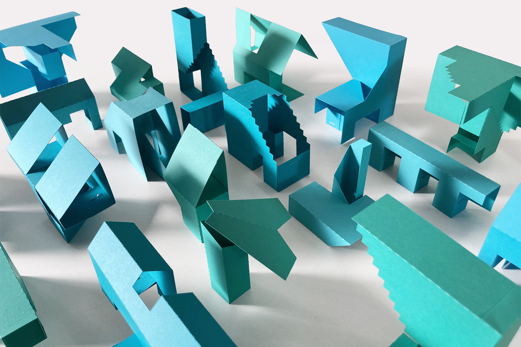 Modular Builder Creator Set paper modules arranged on a surface showing geometric shapes for building structures and forms