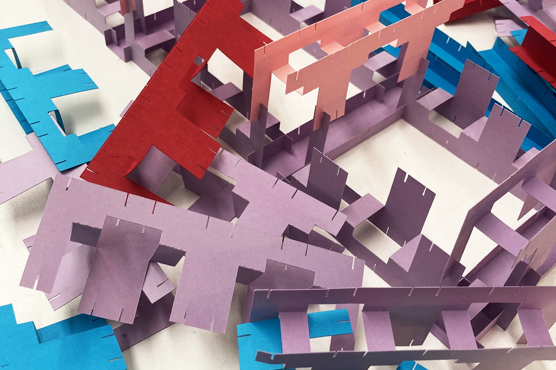 Colorful geometric paper pieces on a white background