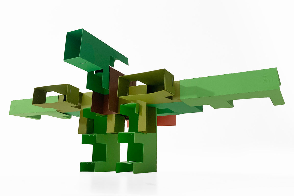 Green geometric paper sculpture on a white background