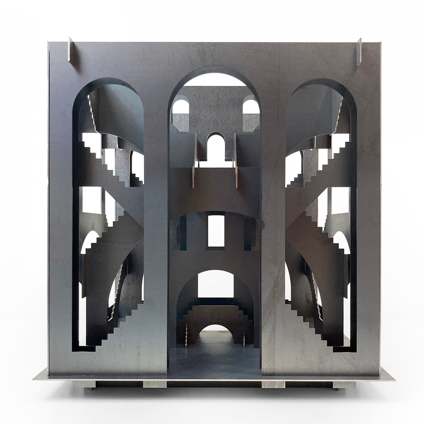 Metallic architectural model with intricate design on a white background