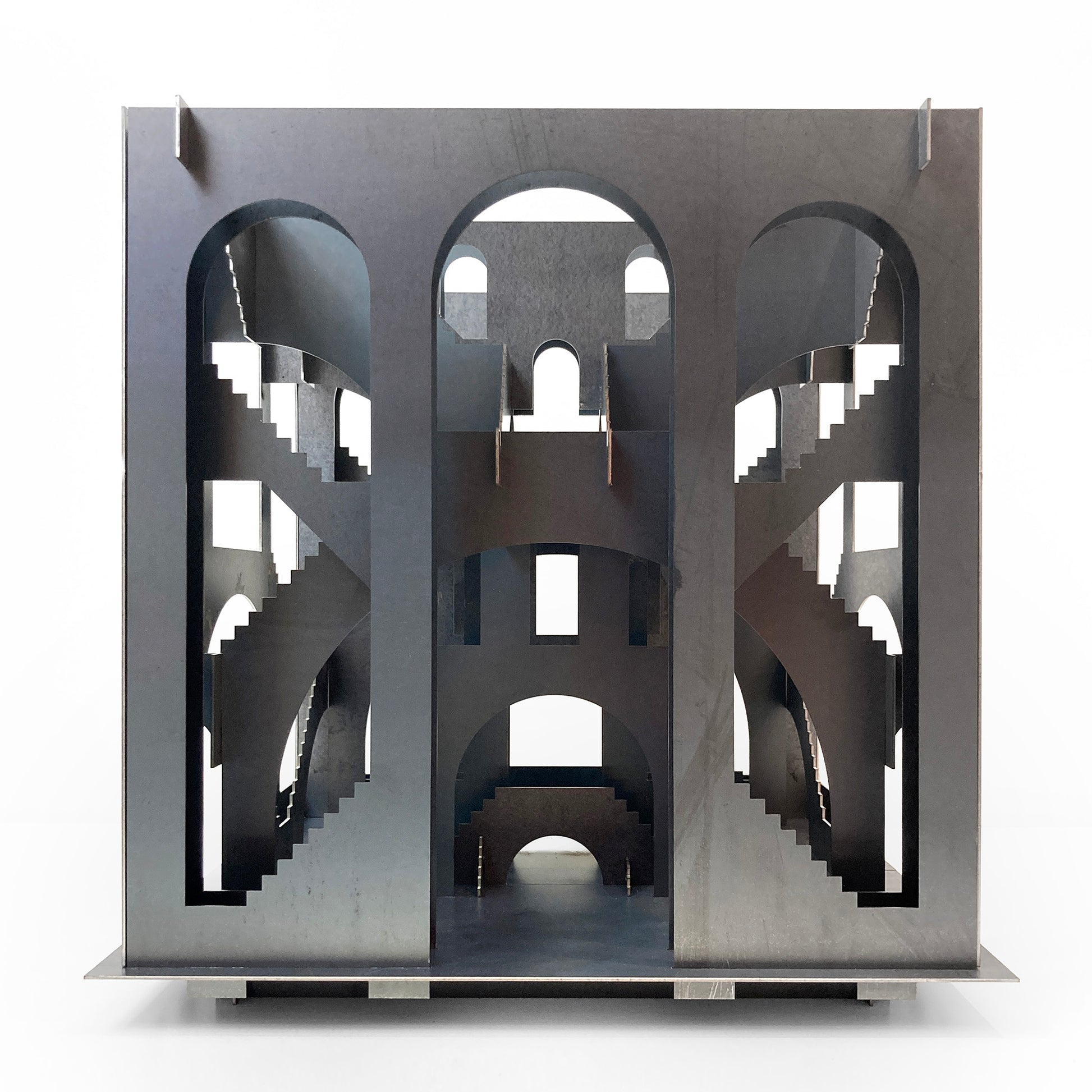 Metallic architectural model with intricate design on a white background