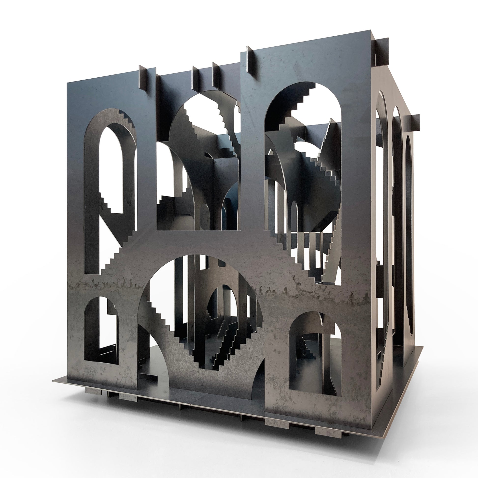 Metallic sculpture with interlocking geometric shapes on a white background