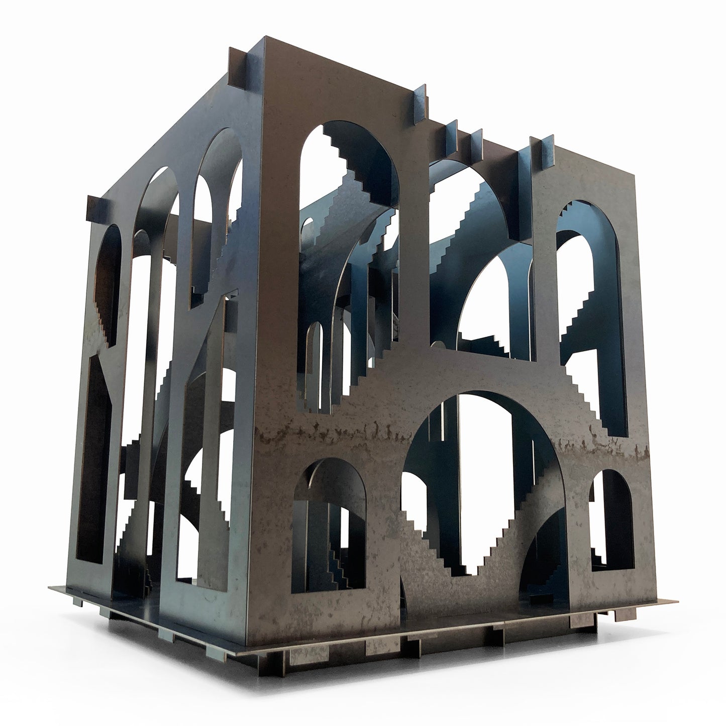 Metallic architectural model with intricate design on a white background