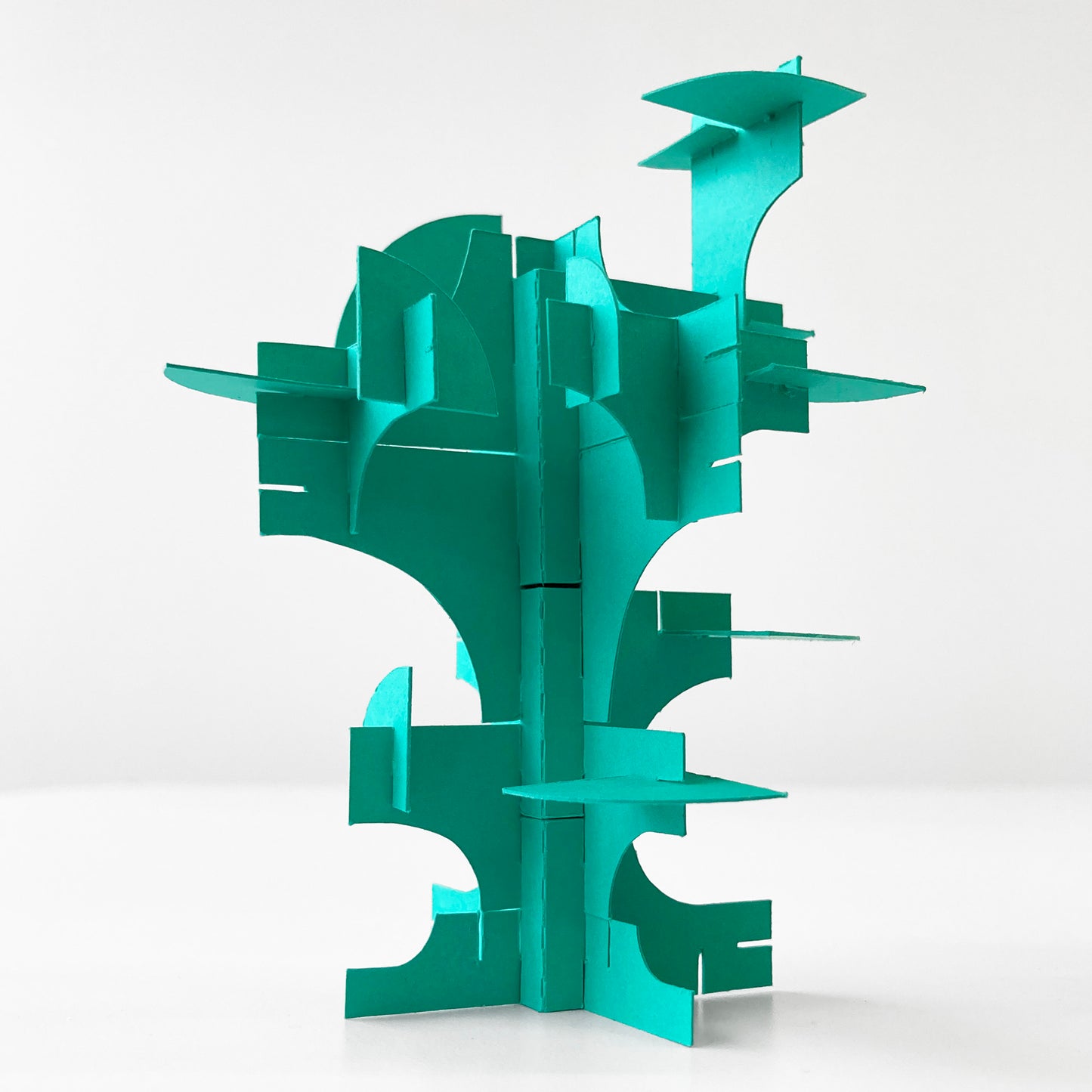Turquoise geometric paper tree structure on a white background