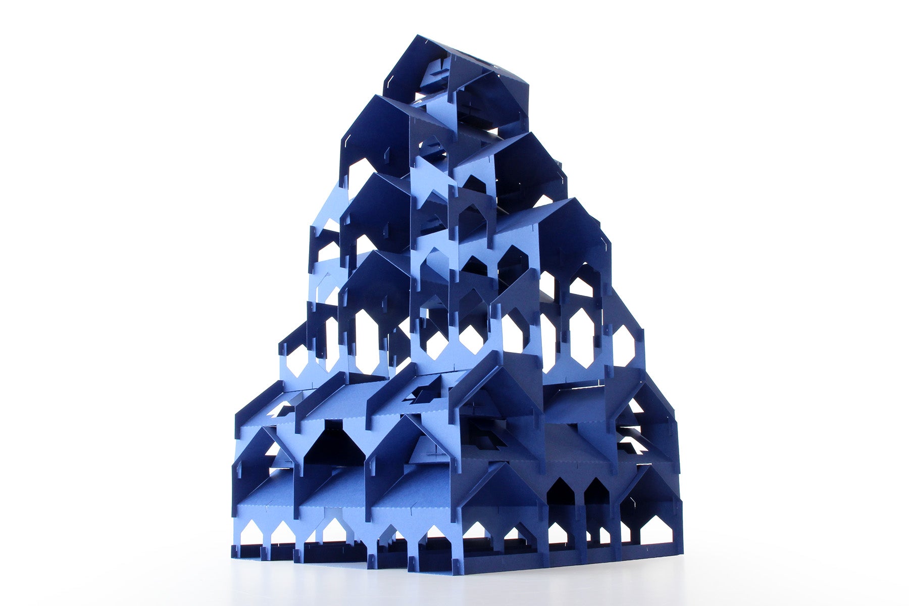 Blue geometric paper pagoda sculpture on a white background