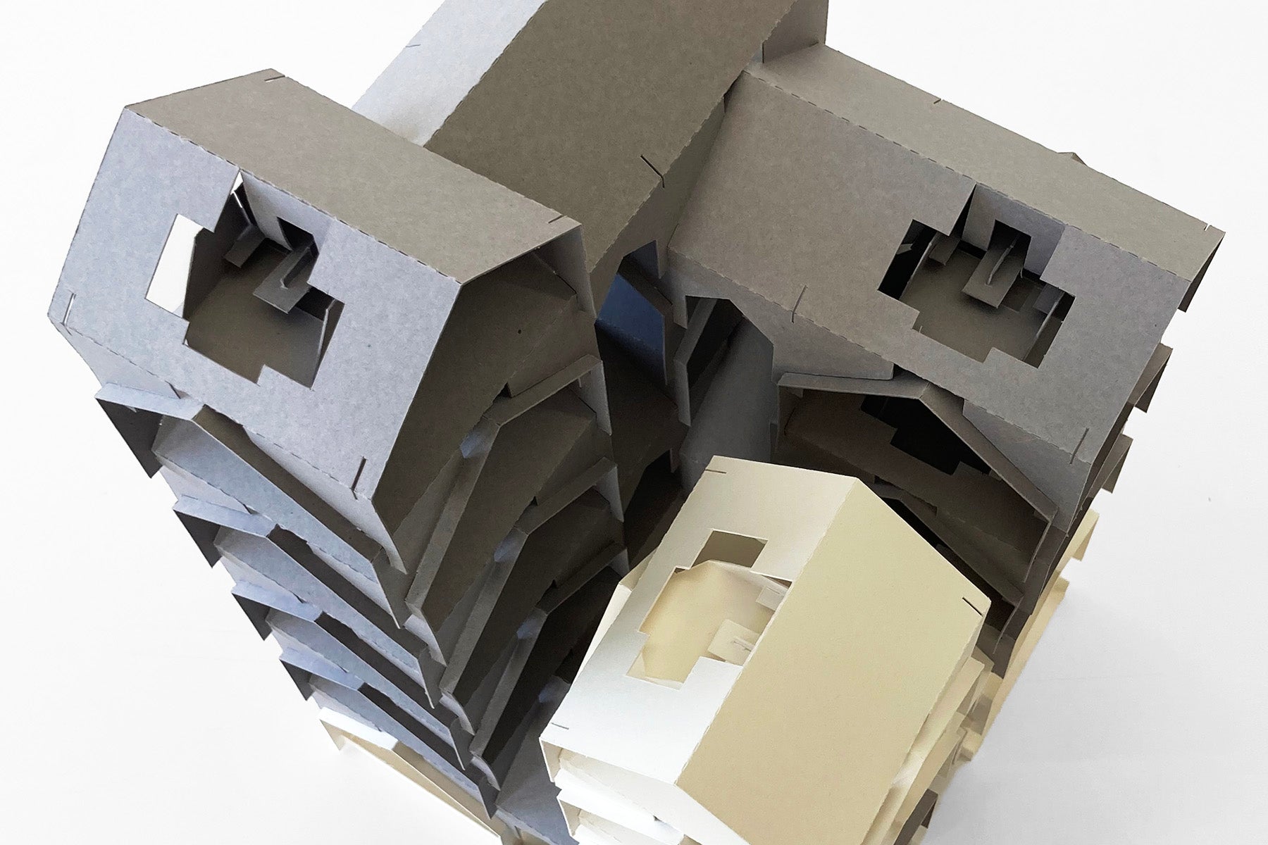 Cardboard model of a building with a white background