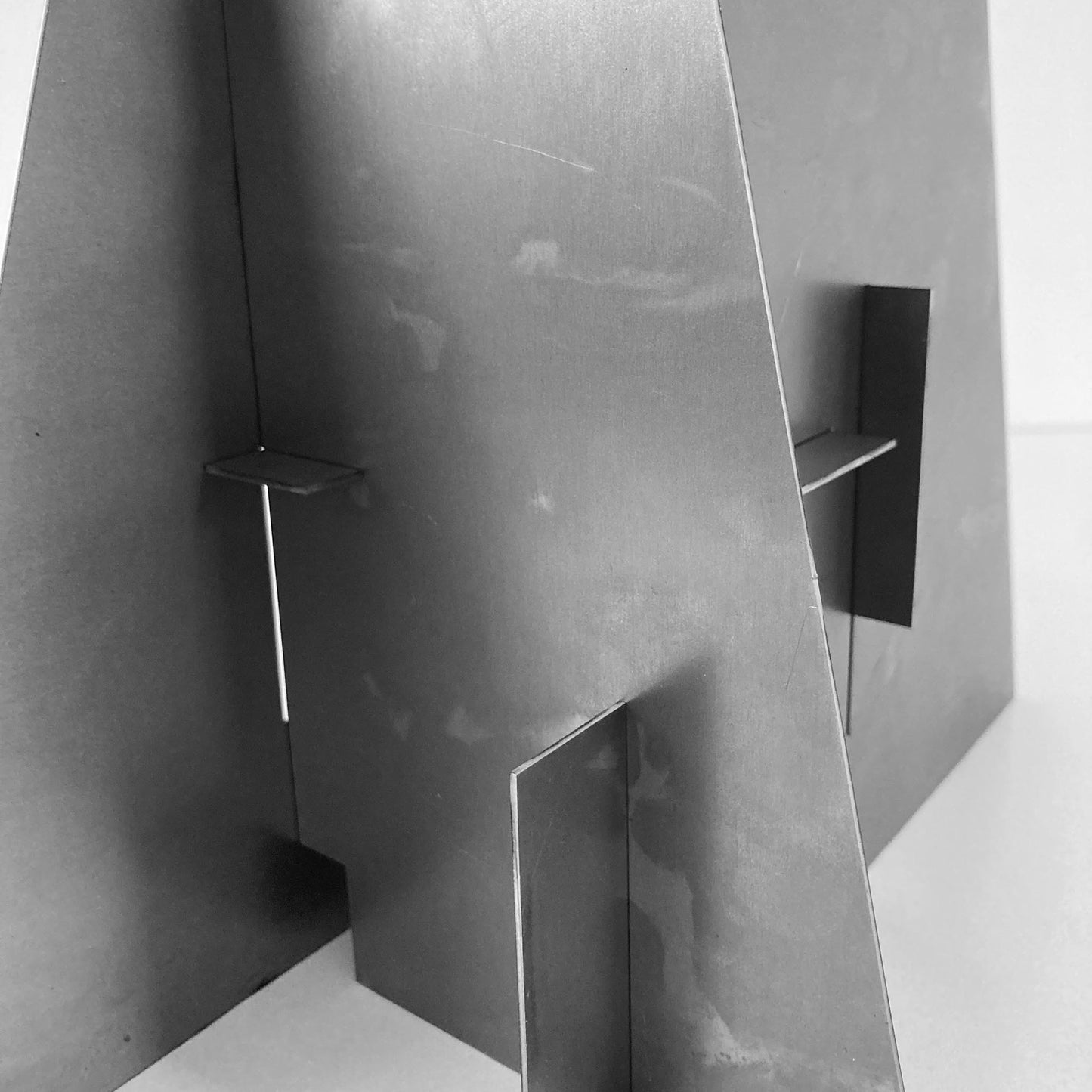 Close-up of a metallic architectural sculpture with geometric design