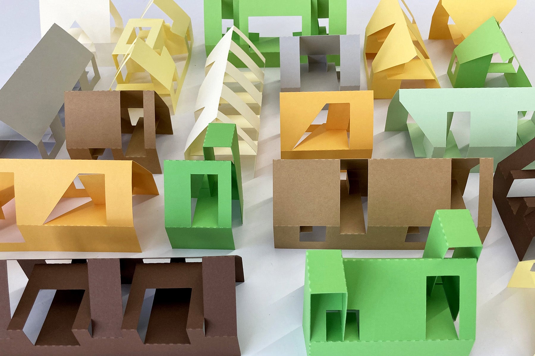 Colorful folded paper houses on a white background