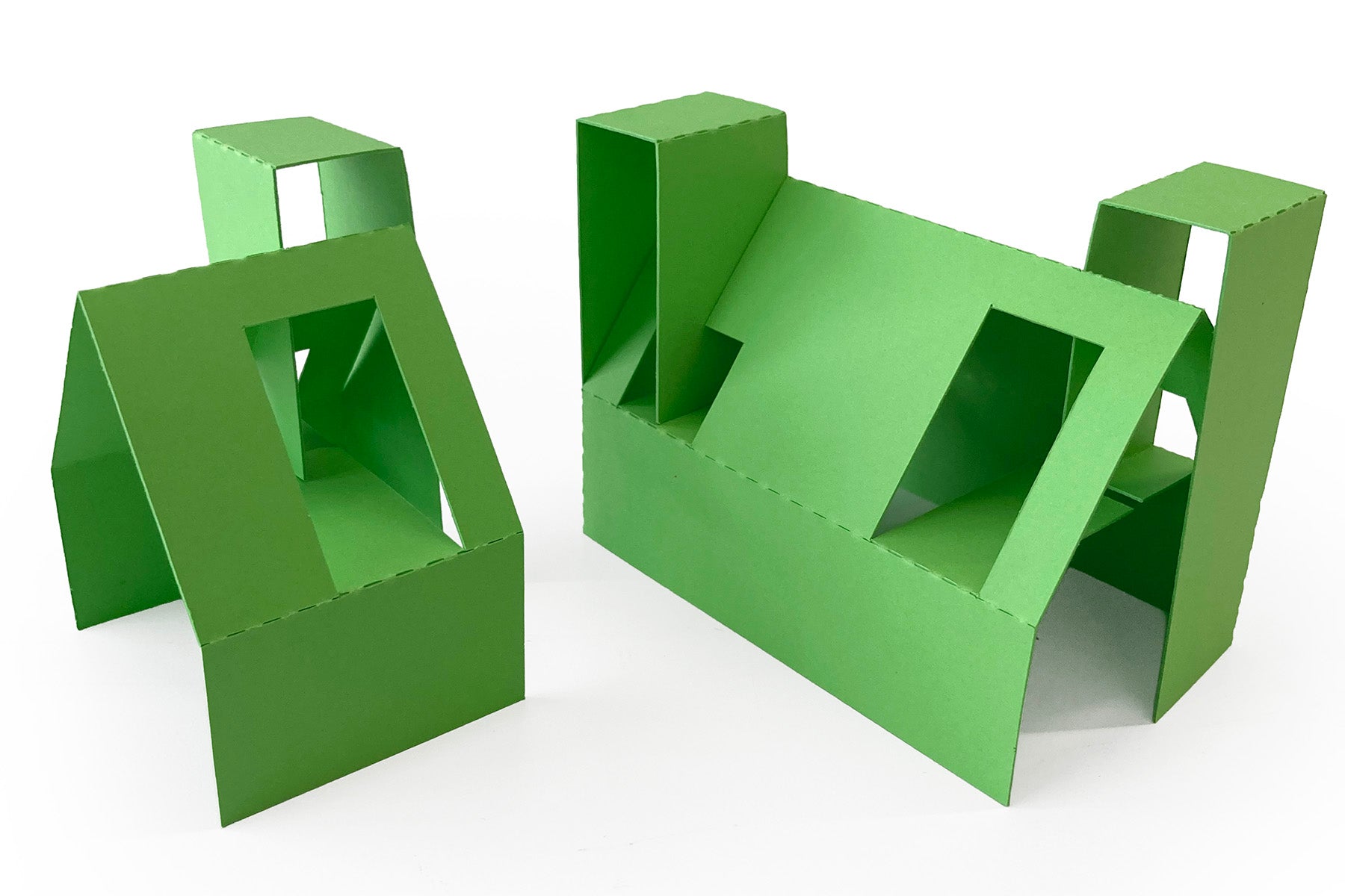 Green cardboard house set on a white background
